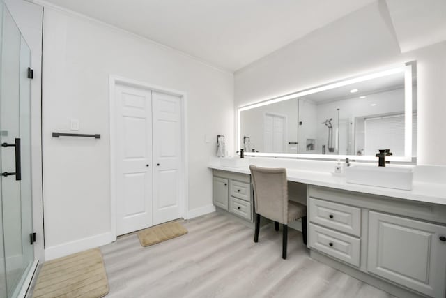 bathroom featuring vanity, a shower with door, and wood-type flooring