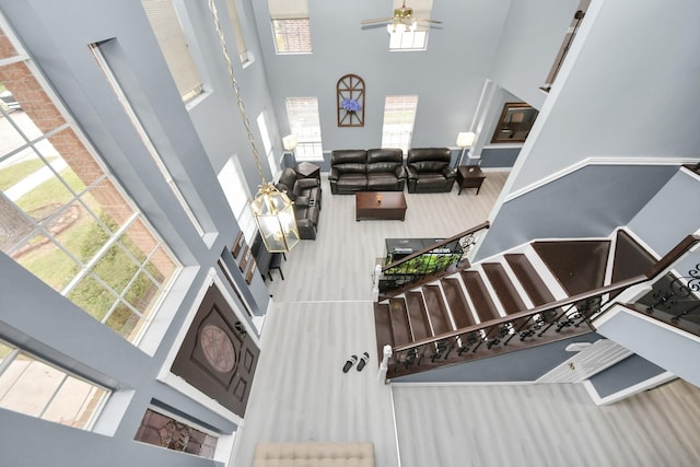 interior space with ceiling fan and a high ceiling