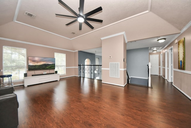 unfurnished living room with lofted ceiling, crown molding, dark hardwood / wood-style floors, and ceiling fan