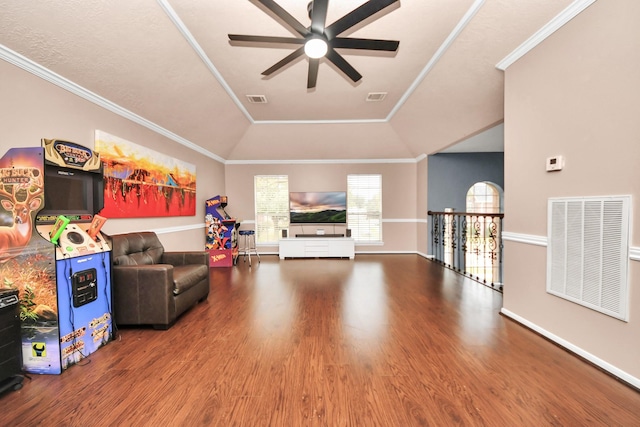 living room featuring hardwood / wood-style flooring, ceiling fan, ornamental molding, and vaulted ceiling