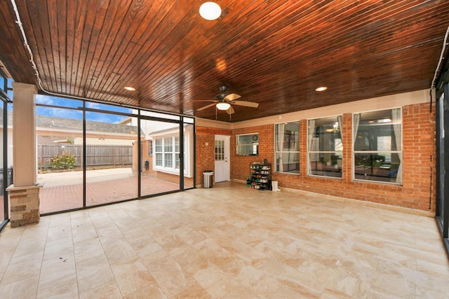 unfurnished sunroom featuring ceiling fan and wood ceiling