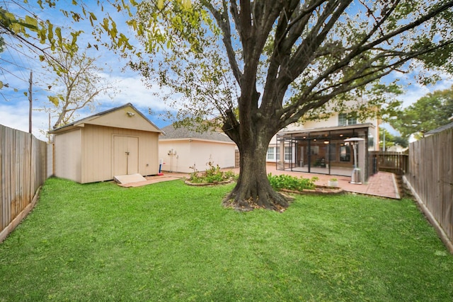 view of yard featuring a shed and a patio area