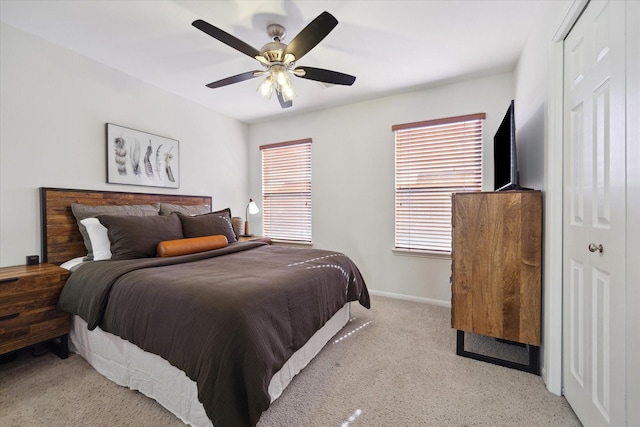 carpeted bedroom with a closet and ceiling fan