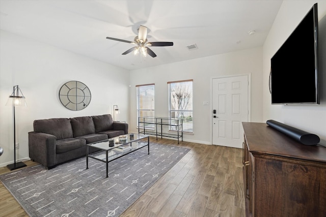 living room featuring hardwood / wood-style flooring and ceiling fan