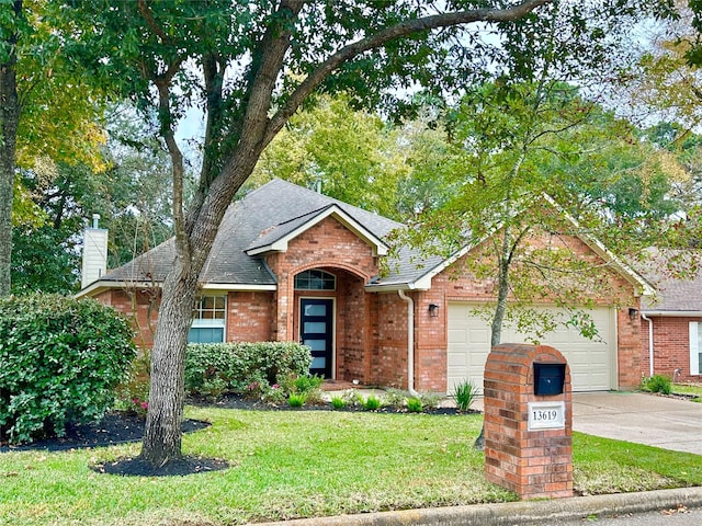 ranch-style home with a front lawn and a garage