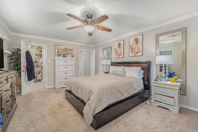 bedroom with ceiling fan, light colored carpet, a closet, and ornamental molding