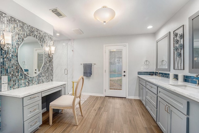 bathroom with an enclosed shower, vanity, and hardwood / wood-style flooring