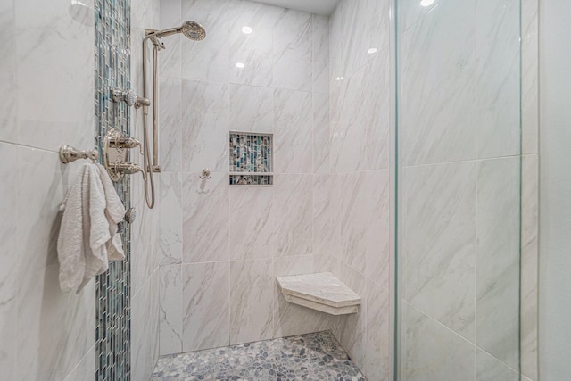 bathroom with a tile shower