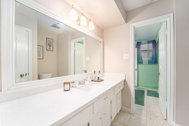 bathroom with toilet and vanity