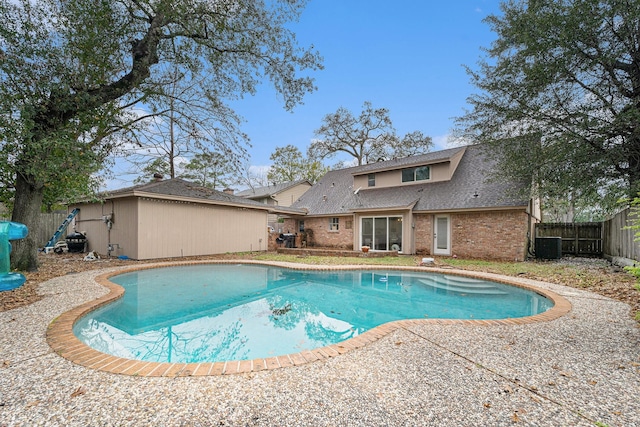 view of swimming pool featuring cooling unit and a patio