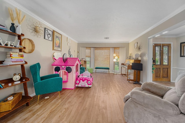 living room with crown molding and light wood-type flooring