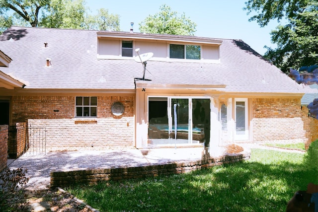 rear view of property with a patio area and a lawn