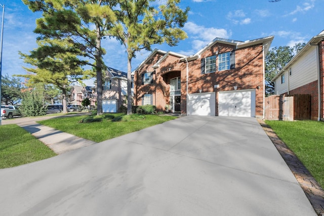 view of front of home with a front yard and a garage