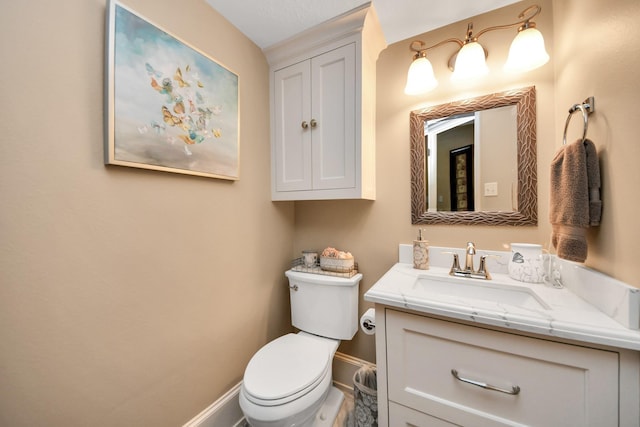 bathroom featuring toilet and vanity