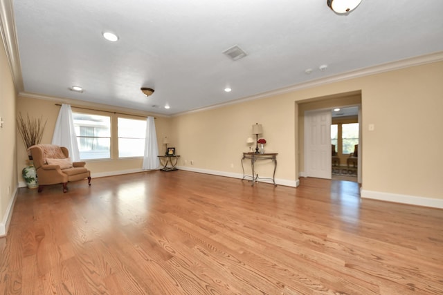 interior space with light hardwood / wood-style floors, a wealth of natural light, and crown molding