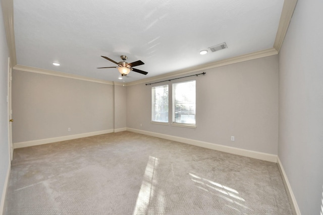 carpeted spare room featuring ornamental molding and ceiling fan