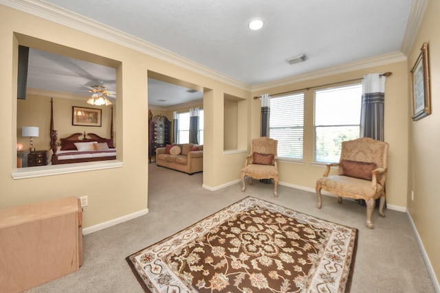 sitting room with ornamental molding, ceiling fan, and light colored carpet