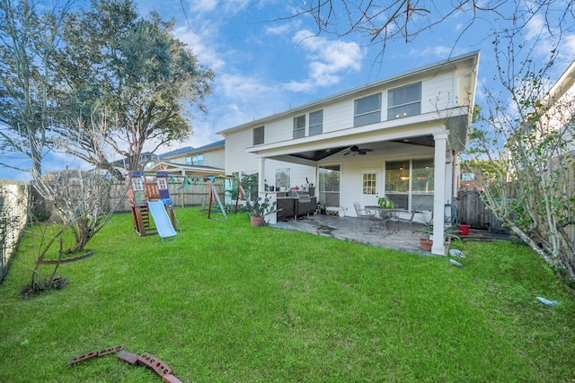 rear view of house featuring a patio area, ceiling fan, a playground, and a lawn