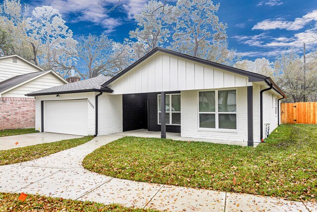 ranch-style home with a garage and a front yard