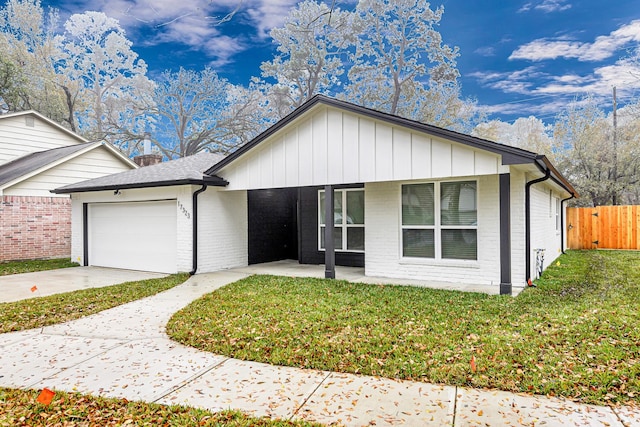 ranch-style house with a garage and a front lawn