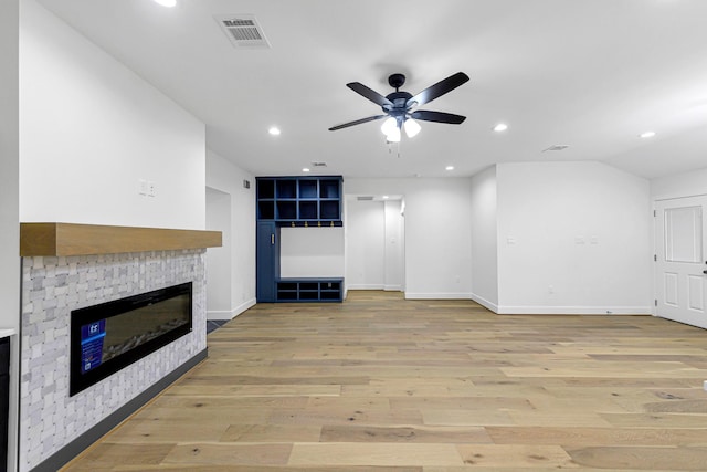 unfurnished living room with ceiling fan and light wood-type flooring