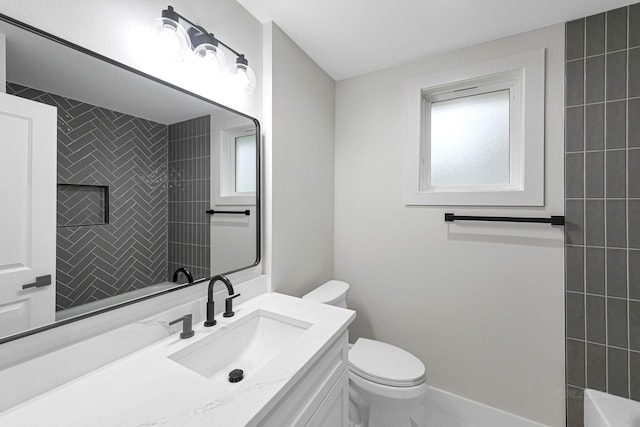 bathroom with vanity, a wealth of natural light, and toilet