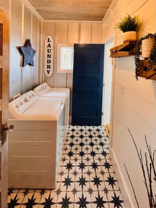 washroom with wooden ceiling, washer and clothes dryer, and wooden walls