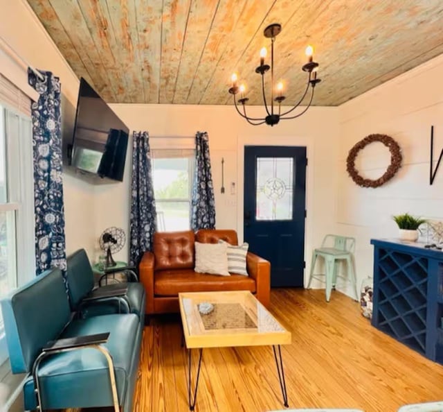 living room with an inviting chandelier, wood ceiling, and wood-type flooring