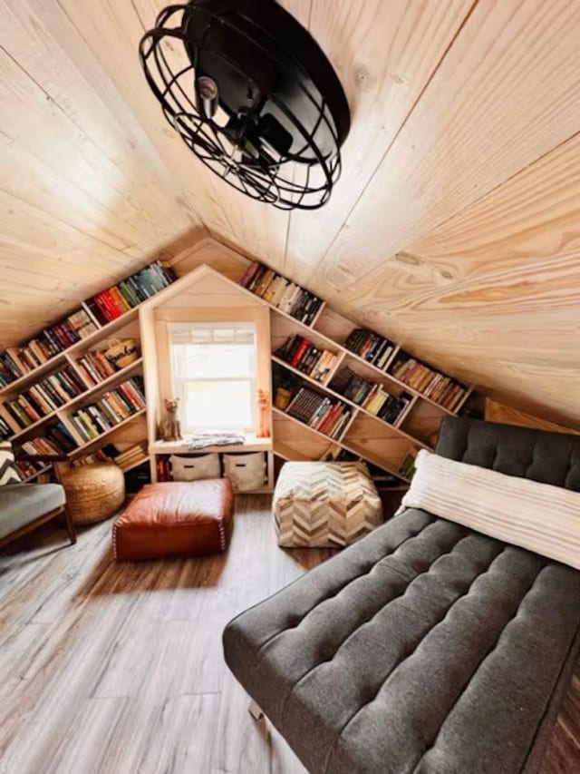 interior space featuring lofted ceiling, wood ceiling, wooden walls, and hardwood / wood-style flooring