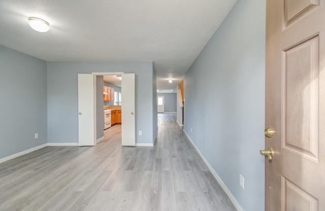 interior space featuring a textured ceiling and light hardwood / wood-style flooring