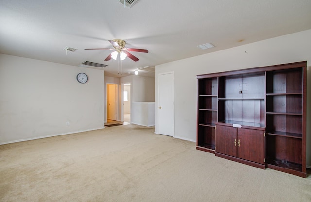 unfurnished living room with ceiling fan and light colored carpet