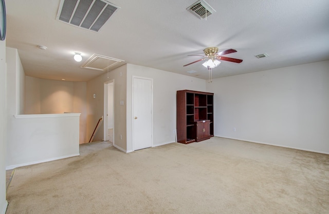 carpeted spare room featuring ceiling fan