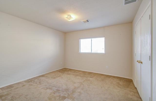 spare room with light carpet