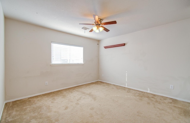 unfurnished room with ceiling fan and light carpet