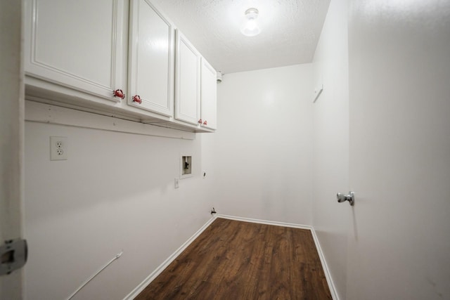 laundry room with dark hardwood / wood-style flooring, washer hookup, a textured ceiling, and cabinets