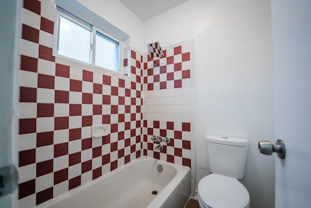 bathroom featuring toilet and a tub to relax in