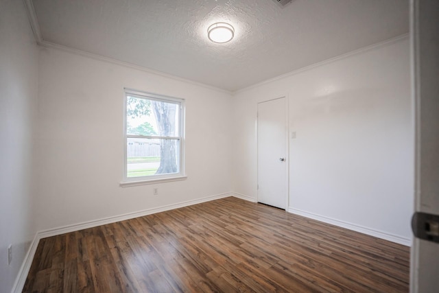 unfurnished room with a textured ceiling, crown molding, and dark hardwood / wood-style floors