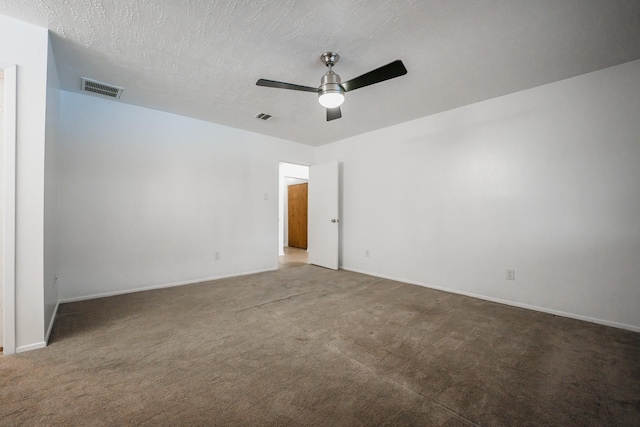 carpeted spare room featuring a textured ceiling and ceiling fan