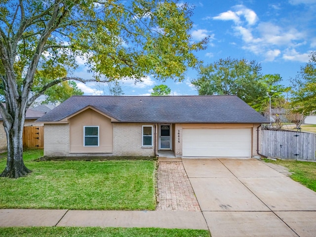 single story home featuring a garage and a front lawn