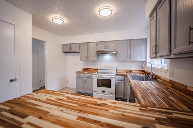 kitchen featuring gray cabinetry, wood counters, white range with electric stovetop, a textured ceiling, and sink