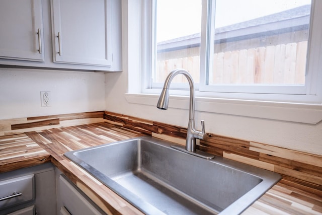 details featuring sink, butcher block counters, and gray cabinetry