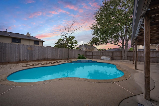 pool at dusk with a patio