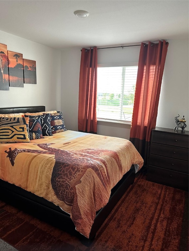 bedroom with dark hardwood / wood-style floors