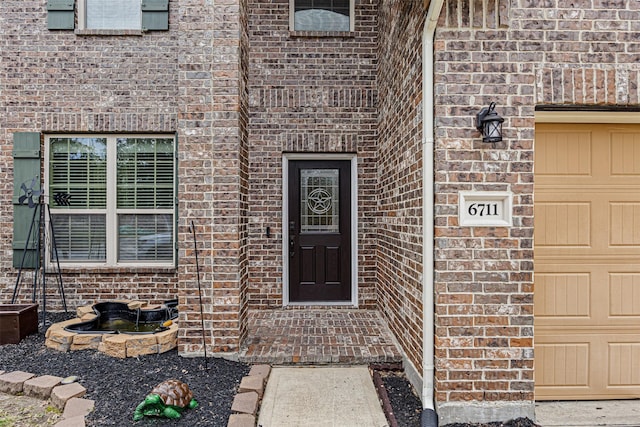 doorway to property with a garage