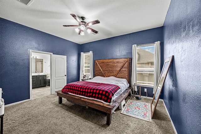 bedroom featuring a textured ceiling, ceiling fan, carpet, and ensuite bath