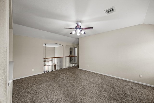 empty room featuring ceiling fan, lofted ceiling, and carpet flooring