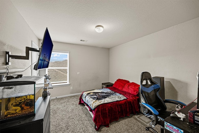 bedroom with a textured ceiling and carpet floors