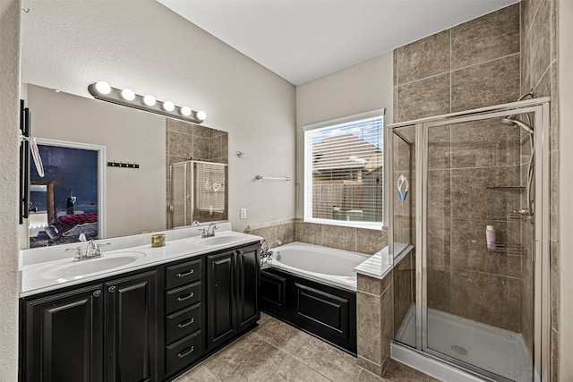 bathroom with tile patterned flooring, separate shower and tub, and vanity