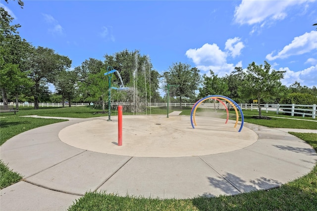 view of home's community featuring a lawn and a playground