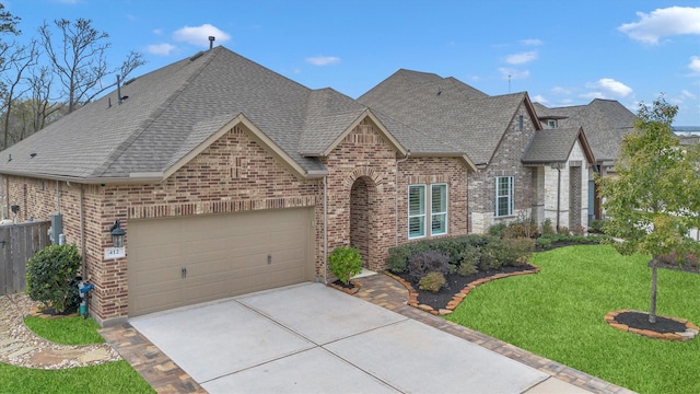 view of front of house featuring a garage and a front lawn